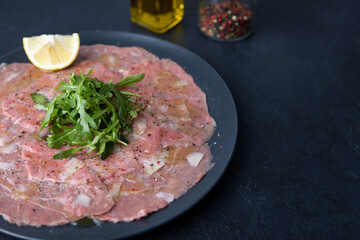 Marbled beef carpaccio with arugula, parmesan cheese, olive oil and lemon. A traditional classic...