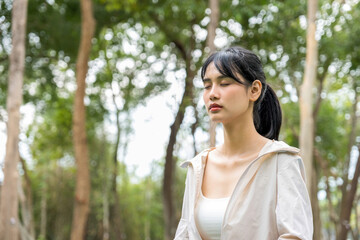 Young woman is meditating at natural park.