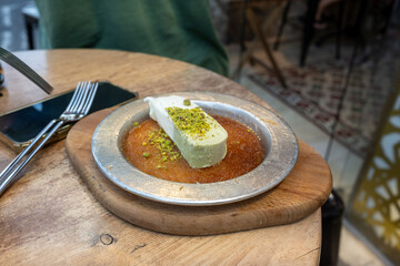 Knafeh with pistachio on plate