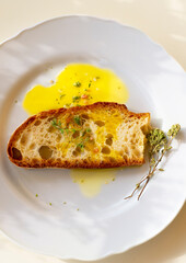 Bruschetta, Italian Tonscan bread with oregano and olive oil. Italian simple cuisine, iconic Italian ingredients. Sun glare, natural eco style