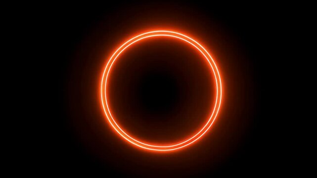 Vibrant orange neon ring gradually completes its shape against a dark background, emitting a bright and luminous glow
