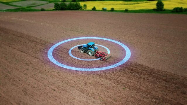 Autonomous tractor drives through a field and plows the land with a plow. Modern efficient agriculture, self-driving agricultural machinery. 4k footage