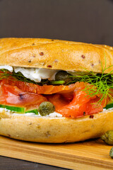 close up of smoked salmon bagel, with all the trimmings, portrait.