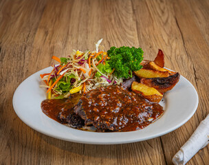 Traditional English pub food. Steak pie, chips, salad, ready to eat.