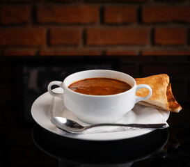 Cream soup of carrots with bread. Could also be tomato soup.