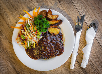 Traditional English pub food. Steak pie, chips, salad, ready to eat.