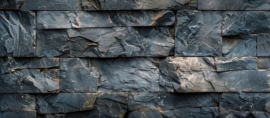 Fototapeta premium Gray granite stone wall with a rough surface texture ideal as a background for a copy space image