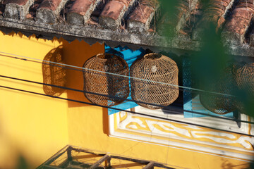 hanging lamp in birdcage at Hoi An old town with yellow wall background