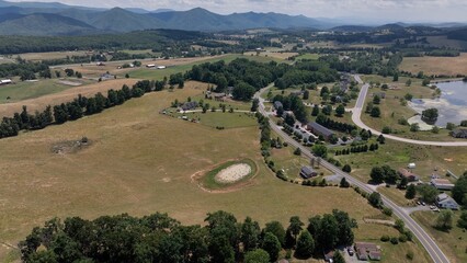 Fototapeta premium Peaceful landscape with Blue Ridge Mountains and farmland countryside with small town life