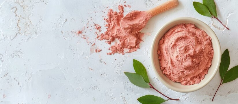 White bowl with red Moroccan bentonite clay for DIY beauty treatments like facial masks body wraps or hair care View from above with copy space image