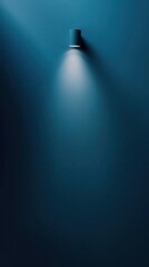 Minimalist wall lamp casting a beam of light on a teal wall.