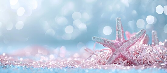 Festive concept with silver and pink star glitter against a blue pastel backdrop providing copy space image