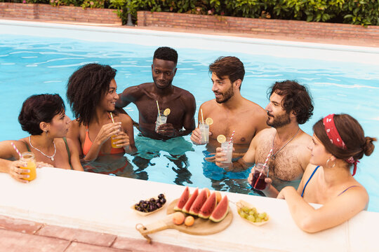 Group of Friends Socializing in Pool - Summer Pool Party