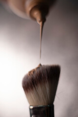 makeup brush  and foundation cream