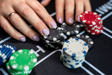 Naklejka premium feman player makes a bet, and puts a chip at casino. Gambling concept. Chance to win