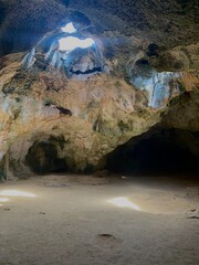 rock cave with hole of sunlight