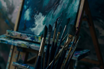 Fototapeta premium Artistic Tools and Canvas in a Painter's Studio Brushes, Easels, and Abstract Art
