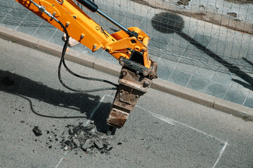 hydraulic jackhammer mounted on an excavator © nito