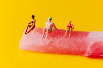 miniature people in swimsuit on a freeze pop