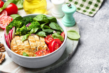 Healthy meal. Delicious chicken, vegetables and spinach served on light grey table, space for text