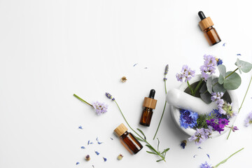 Aromatherapy. Essential oils, flowers, eucalyptus leaves, mortar and pestle on white background,...