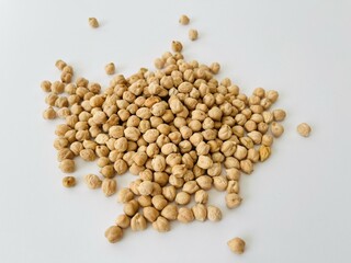 Raw dry chickpea in small ceramic bowl on white background. Traditional ingredient for cooking hummus. Middle Eastern and Mediterranean cuisine. Selected focused