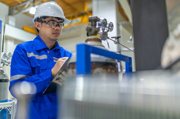 Asian engineer working at Operating hall,Thailand people wear helmet  work,He worked with diligence...
