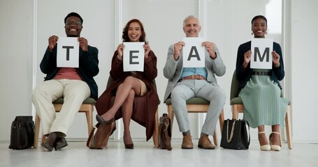 Sign, smile and team of business people in row, sitting on chairs with paper poster for solidarity. Collaboration, corporate and togetherness with happy employee group holding letter text for unity - Powered by Adobe