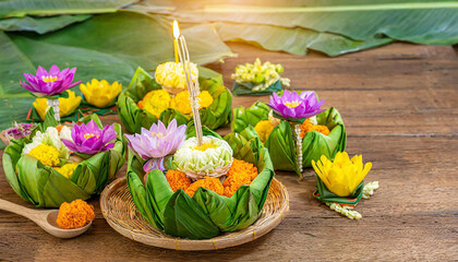 krathong ,hand crafted floating basket by banana leaf,decorated with flowers and incense sticks, candle,light and float on water to celebrate festival Loy Krathong