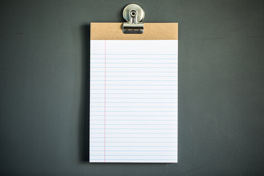 Lined note paper on dark gray magnet board