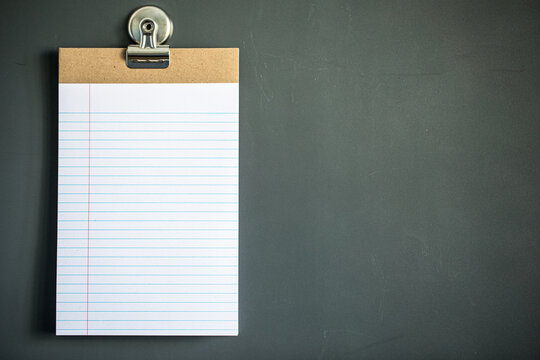 Lined note paper on dark gray magnet board