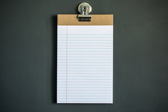Lined note paper on dark gray magnet board