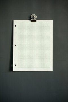 Green graph paper on dark gray magnet board