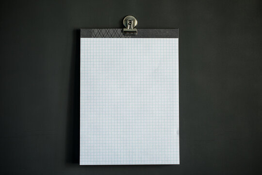 White graph paper on dark gray magnet board