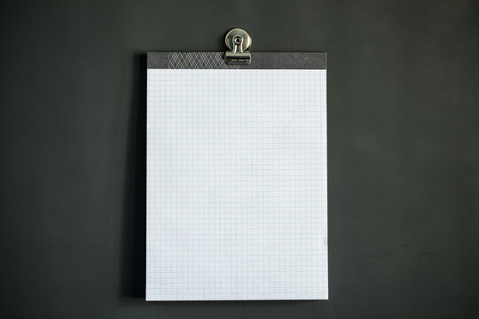 White graph paper on dark gray magnet board