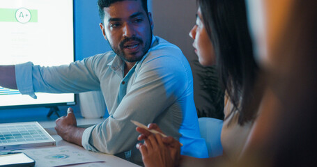 Group diverse Asia businesspeople talk ESG strategies risk management solar panel workshop night,...