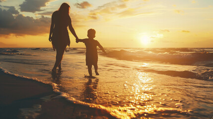 A mother and child walk hand in hand along a beach at sunset, creating a heartwarming scene filled with warm colors and familial love.