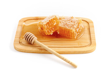 Honeycomb and wooden dipper isolated on white background