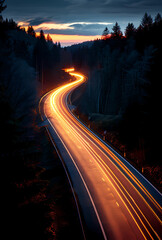 A long exposure photo of a winding road through a forest at dusk, with light trails from passing cars. Perfect for themes of travel, adventure, and motion.

