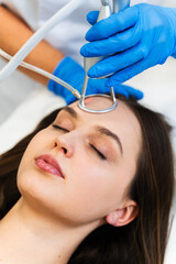 Process of facial CO2 laser resurfacing. Cosmetologist removes wrinkles and scars using laser from...