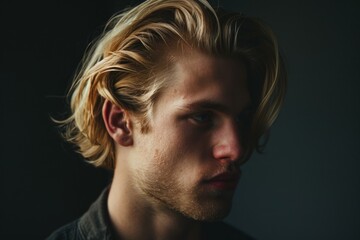 Obraz premium Portrait of a serious young man with long blond hair and a beard