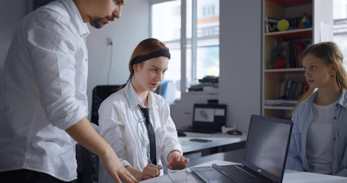 Teacher And School Students Studying Neurobiology, Using Electroencephalography, Mental Activity