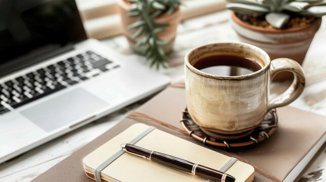 Aerial view of a cozy desk setup featuring a handmade coffee mug