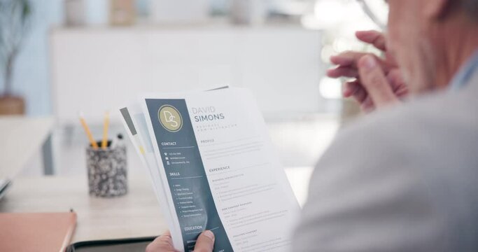Businessman, hands and reading resume with documents for hiring, recruiting or interview of candidates at office. Closeup of man, employer or recruiter with paperwork or career CV for job opportunity