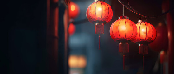 Red lanterns illuminate a dimly lit street, providing a soft glow in the darkness that exudes a mystical and serene night-time atmosphere.