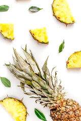 summer dessert with pineapples and leaves on white background top view