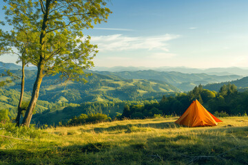 Idyllic camping spot on a grassy hill, overlooking a tranquil valley under a clear blue sky