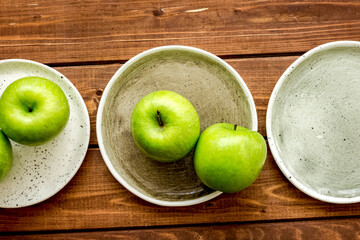 summer food with green apples on wooden background top view