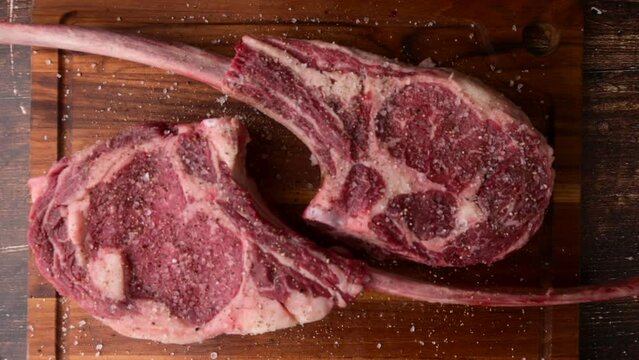 fresh tomahawk beef steak on cutting board