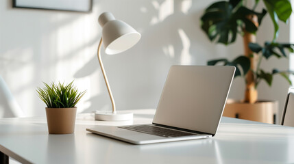 Fototapeta premium A laptop is on a table next to a potted plant